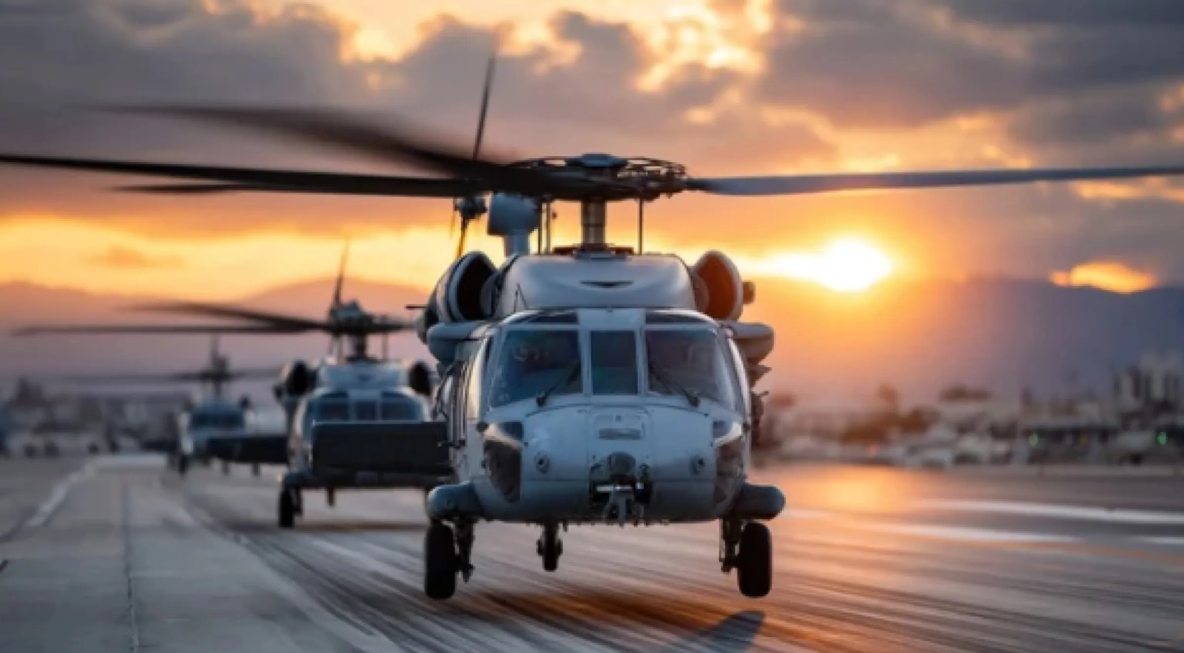 Military rotary-wing aircraft on a runway at dusk