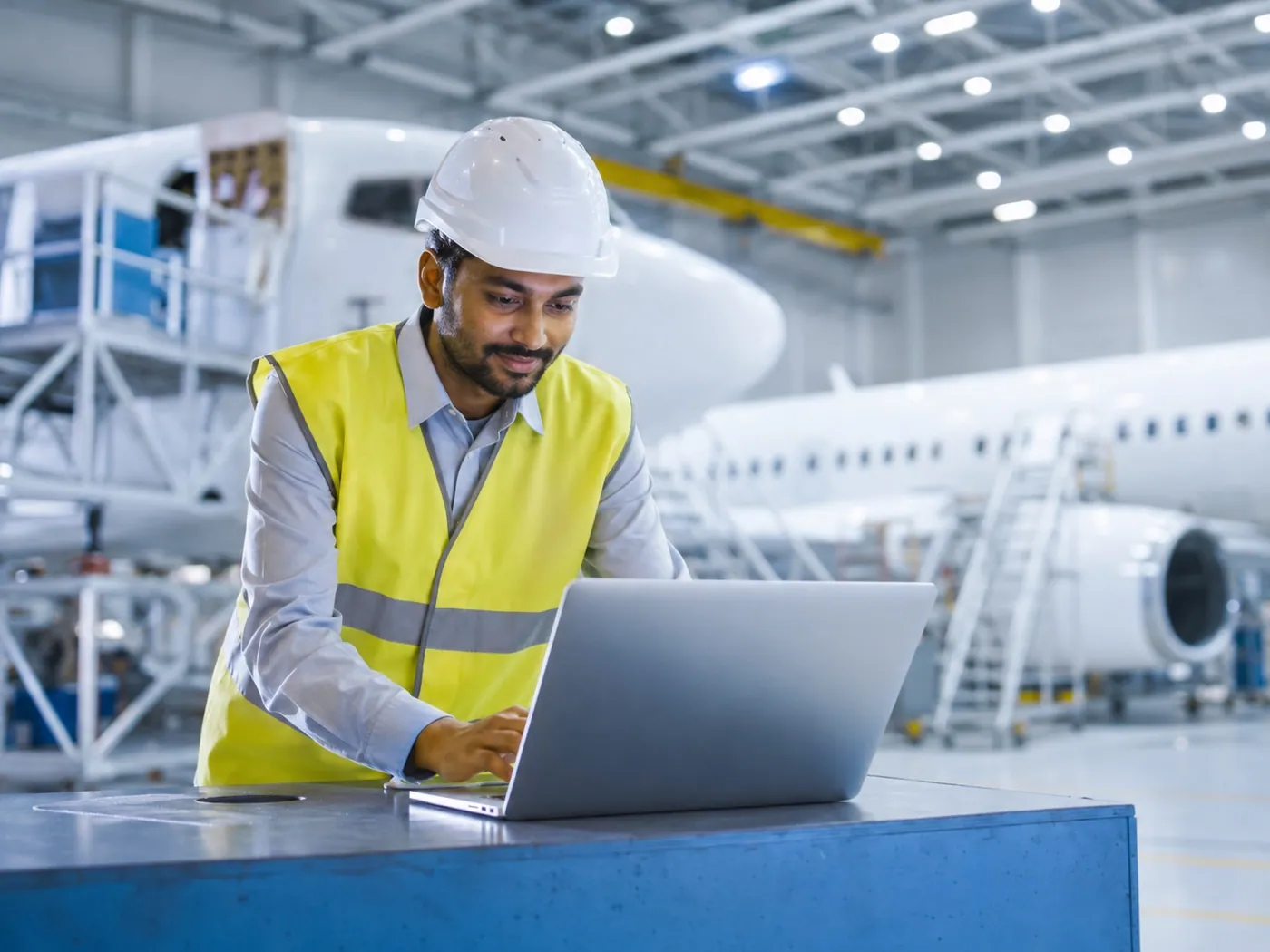 XERIC engineer reviewing maintenance records in an aircraft hangar